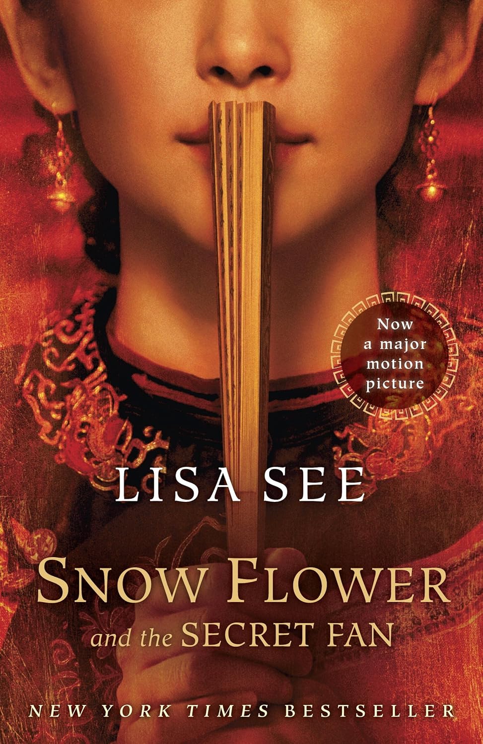Book cover of 'Snow Flower and the Secret Fan' by Lisa See with a woman holding a fan.