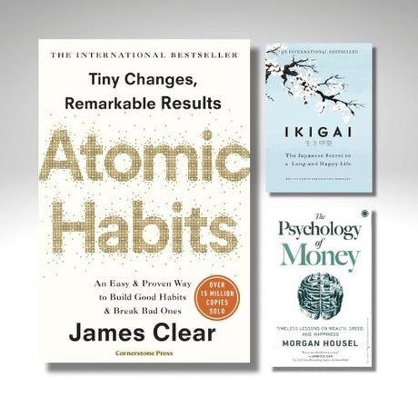 Three books on a gray background: 'Atomic Habits' by James Clear, 'Ikigai' by Michael Lewis, and 'The Psychology of Money' by Morgan Housel.